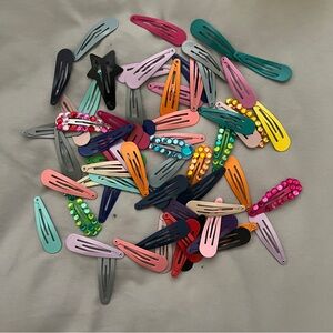 60+ pieces in 2” Barretts metal snap hair clips in assorted colors.